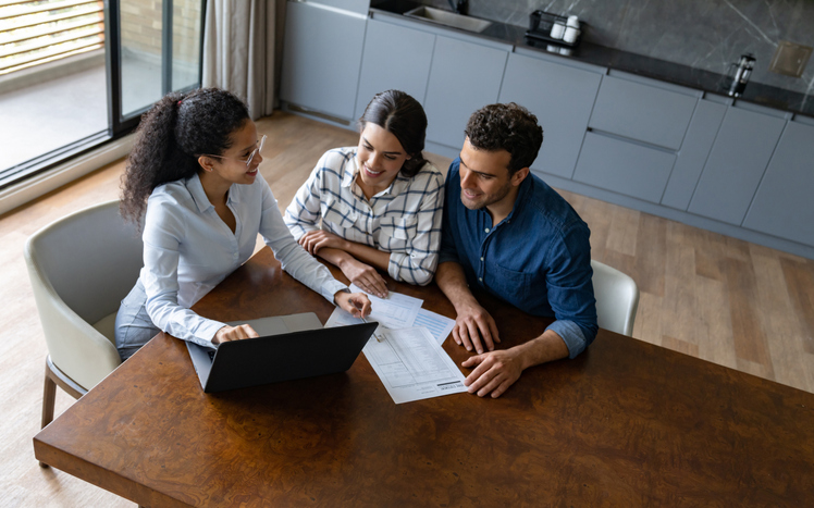 Commercial investors reviewing their portfolio with an advisor.