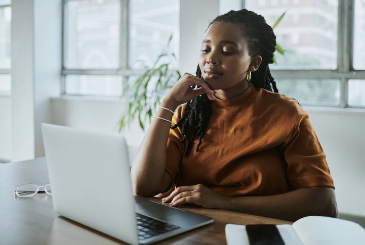 A woman comparing the pros and cons of investing in a high-yield savings account.