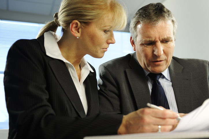 A financial advisor helping a client rebalance their investment portfolio.