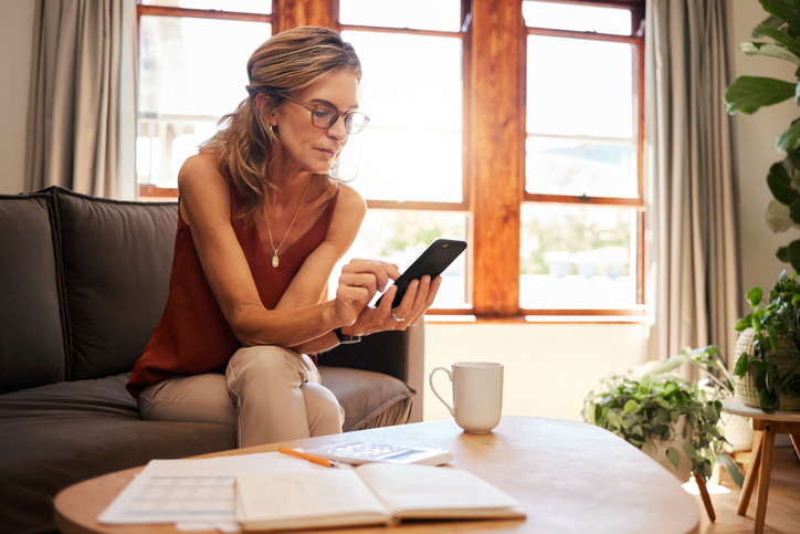 A woman reviewing her portfolio at home.