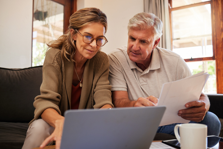 A senior couple looking up the benefits of indexed universal life (IUL) policies.