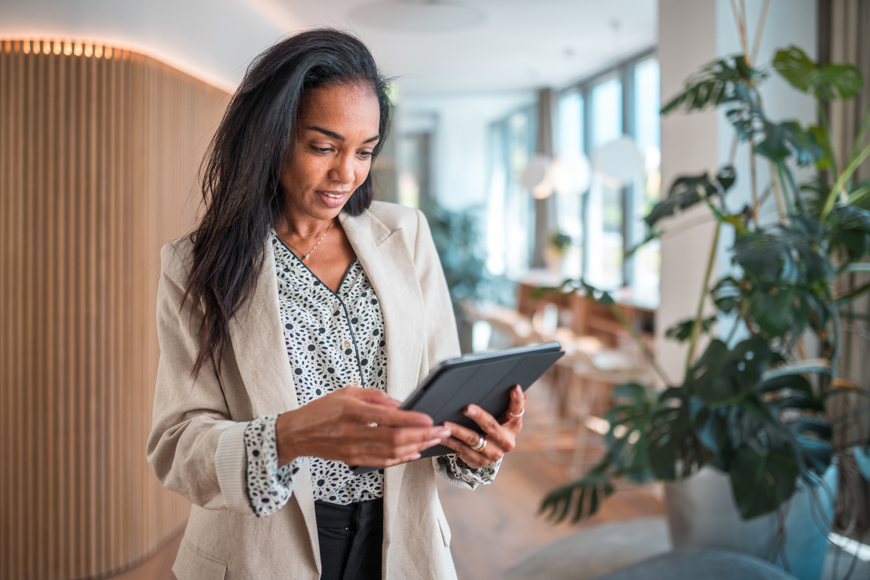 A woman looking up the requirements to qualify for the real estate professional tax status.