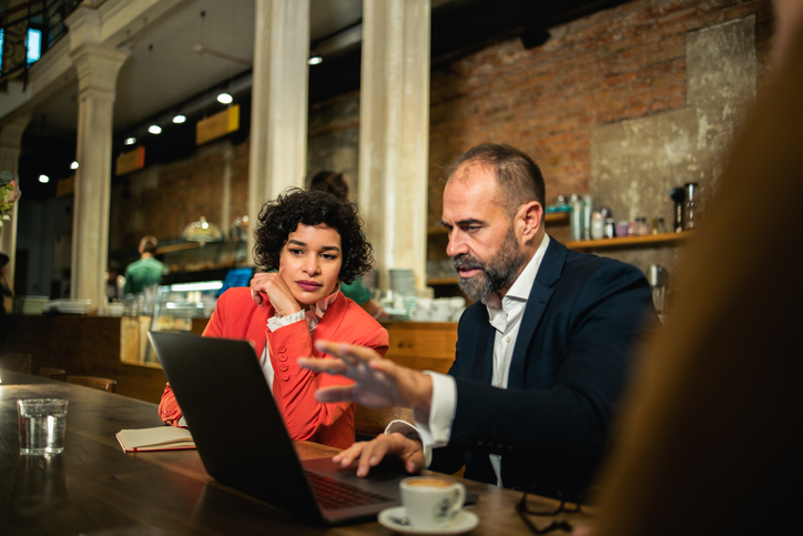 A financial advisor reviewing a 401(k) plan with a business owner.