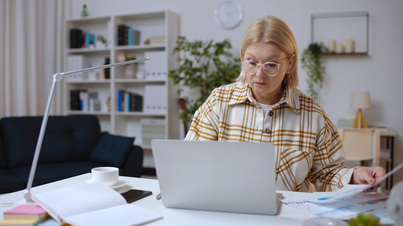 A woman comparing life insurance policies.