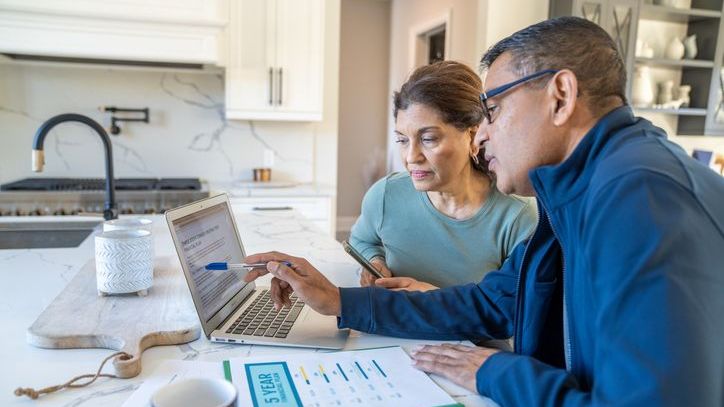 A couple looks over their financial plan to determine whether they should purchase long-term care insurance. 