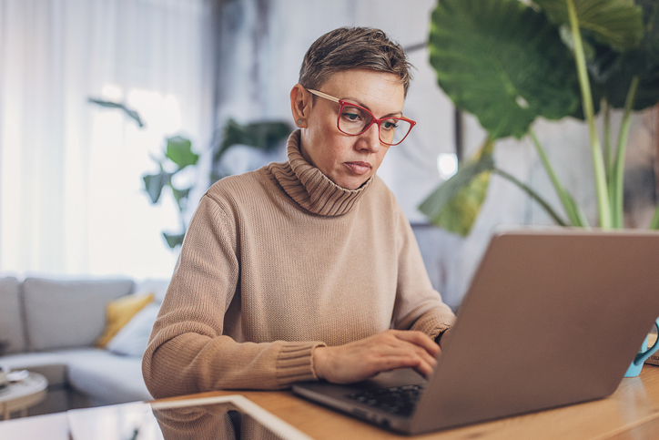 A woman researching the benefits of max-funded indexed universal life insurance.