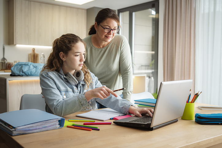 A mother and daughter reviewing a college savings plan.