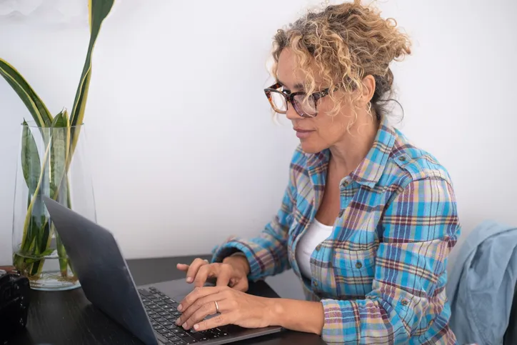 A woman looking up the benefits of indexed universal life (IUL) insurance.