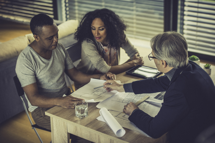 Real estate investors reviewing the plan for an investment property. 