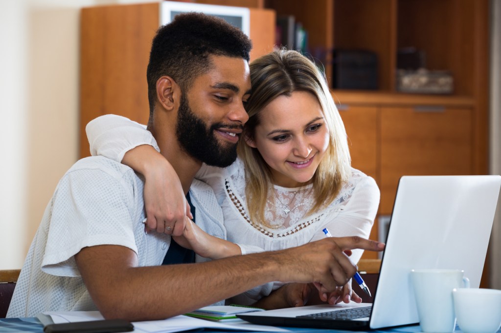 A couple looking up short-term rentals for New York City.