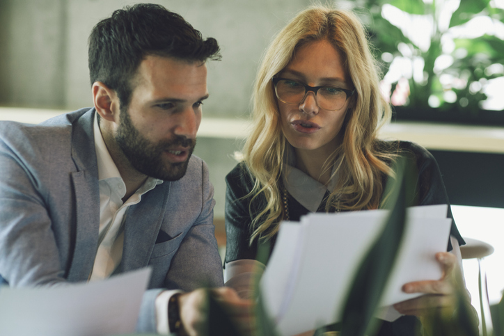 A financial advisor helping an investor put a portfolio together.