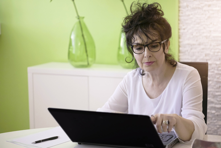 A woman researching strategies to diversify her portfolio.