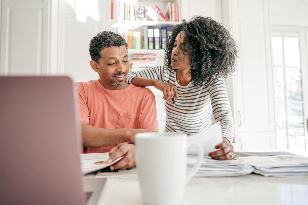 A couple researching common budgeting strategies.