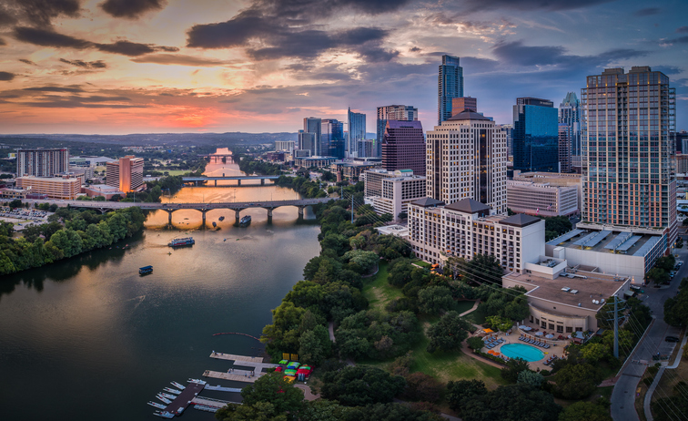 Aerial photo taken over Lady Bird Lake with the Austin, Texas skyline in the background.