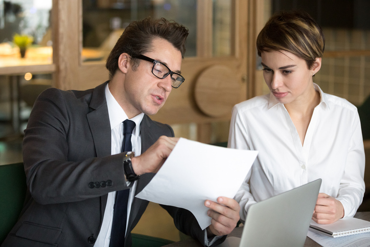 A woman developing a tax strategy for her investments with a tax advisor. 