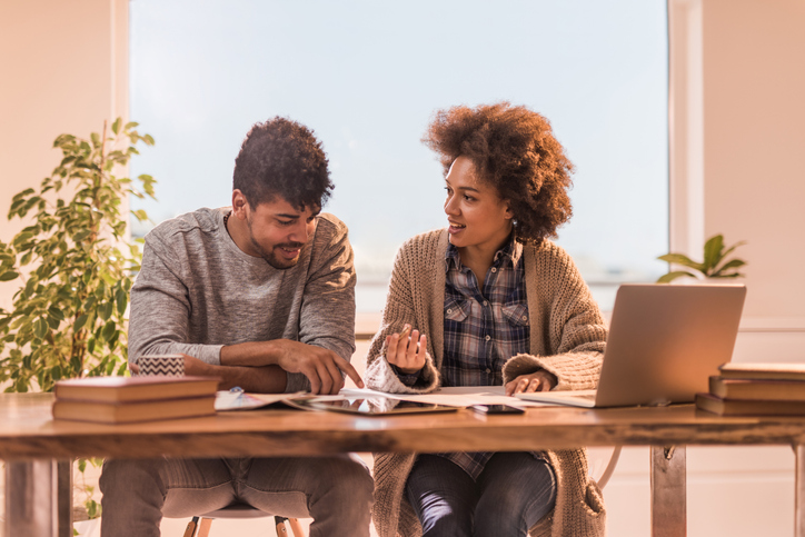 A couple looking up the costs for short-term rental insurance.