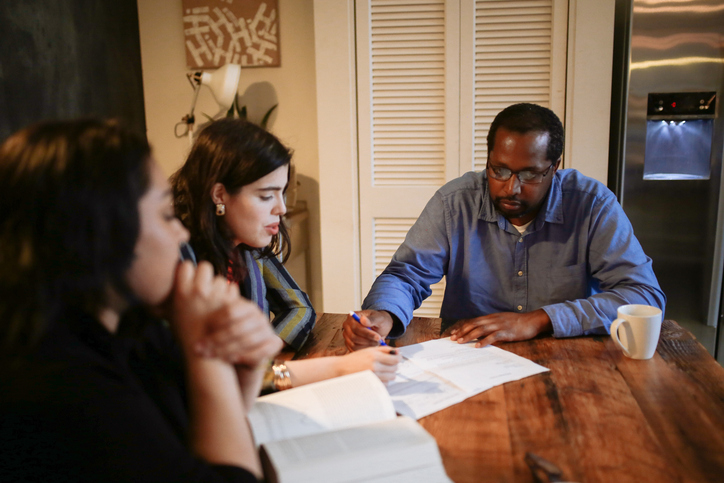 Landlords reviewing eviction documents with a lawyer.