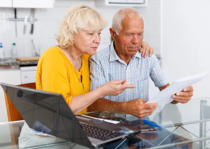 A senior couple reviewing their Social Security benefits.