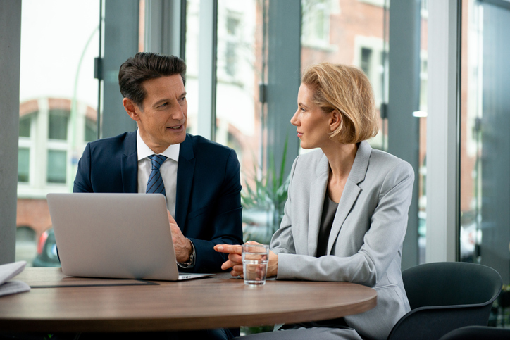 Nasdaq An investor working with a financial advisor. 