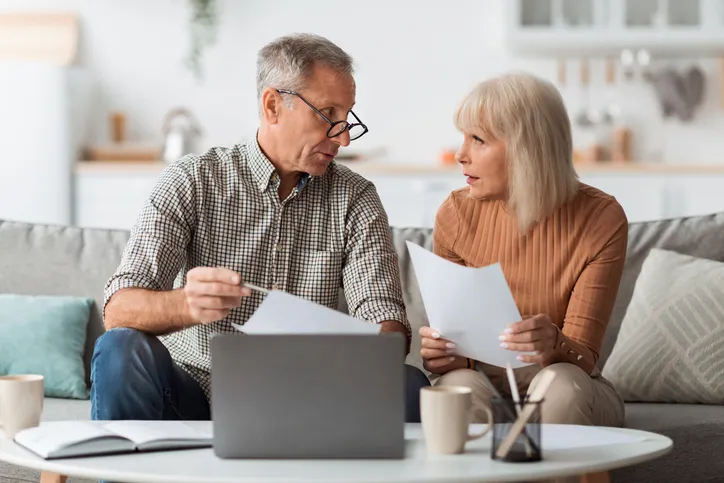 A senior couple discussing a retirement plan to pay for hobbies and activities.