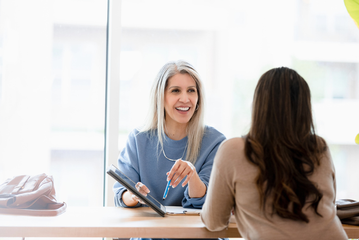 A real estate investor reviewing her portfolio with an advisor.