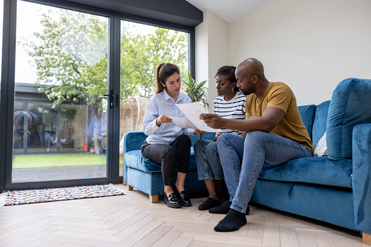 Tenants in Texas reviewing eviction documents with a lawyer.