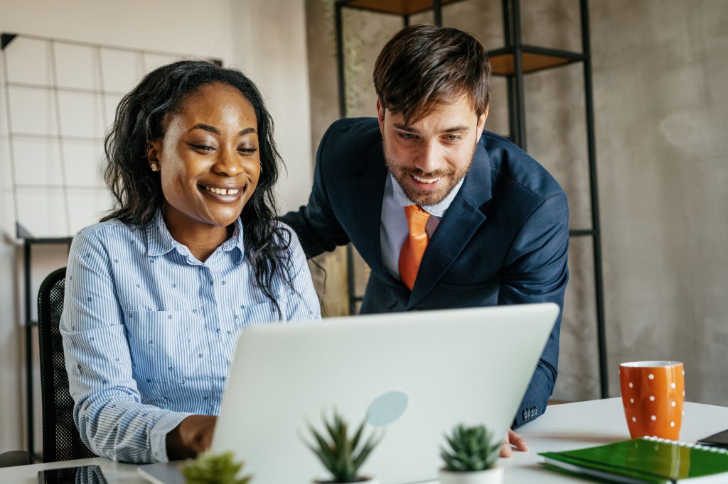 A financial advisor working with a client to determine the insurance coverage they need for their real estate investments.