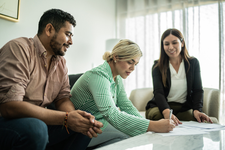 Real estate investors creating a tax plan with a financial advisor.