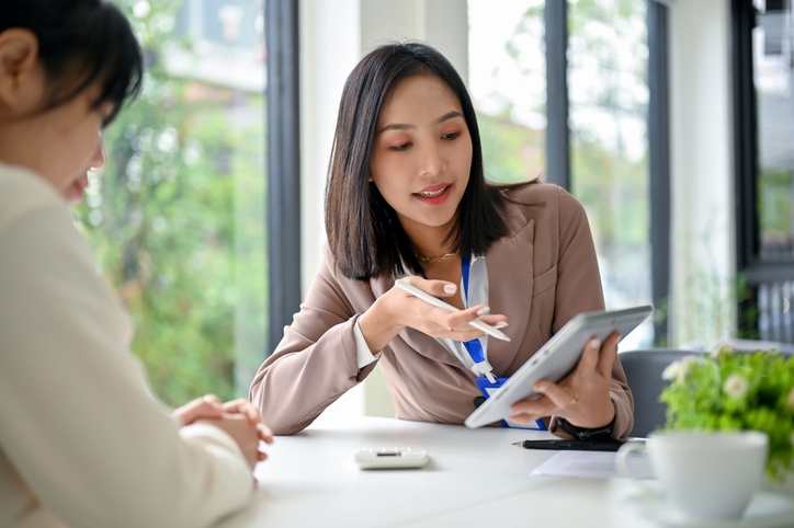 A financial advisor explaining the difference between assessed value and market value.