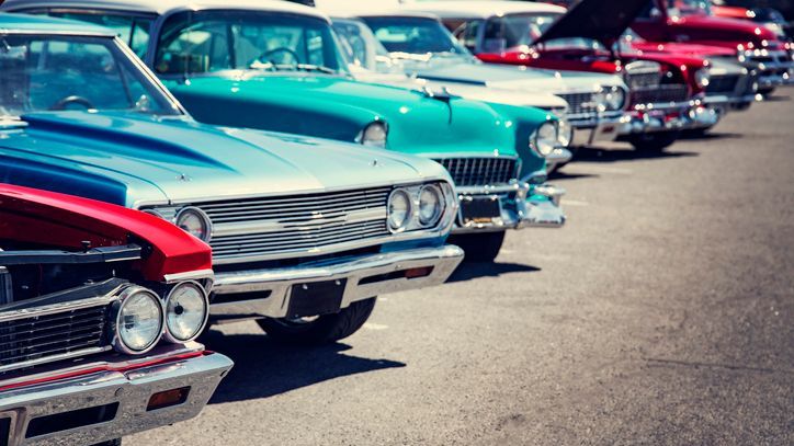 Vintage cars in a row at a car show.