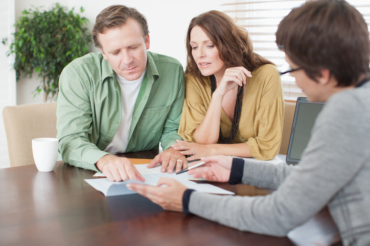 A couple creating an estate plan with a financial advisor.