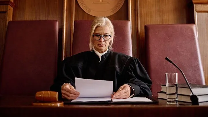 A Connecticut probate judge looks over documents during a probate hearing.