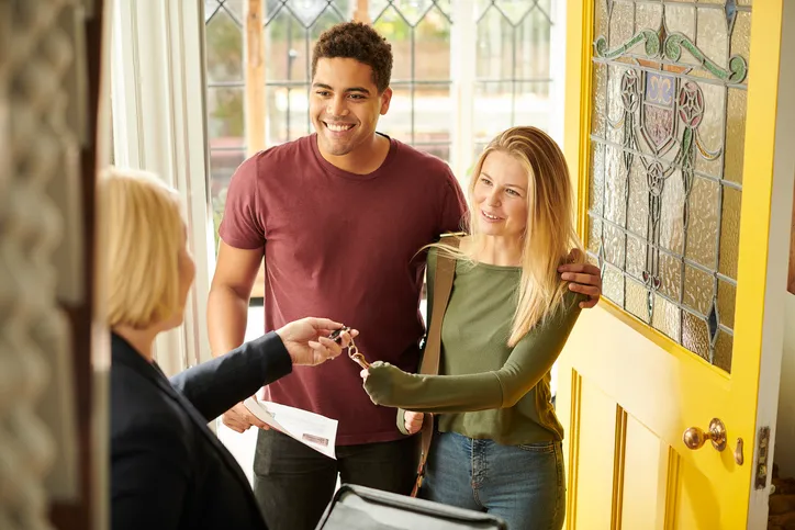 Tenants getting the keys after signing a month-to-month lease.