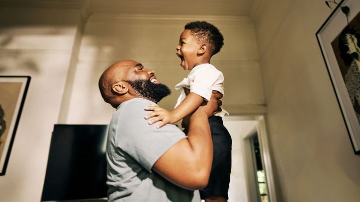 A 30-year-old man embraces his son. 