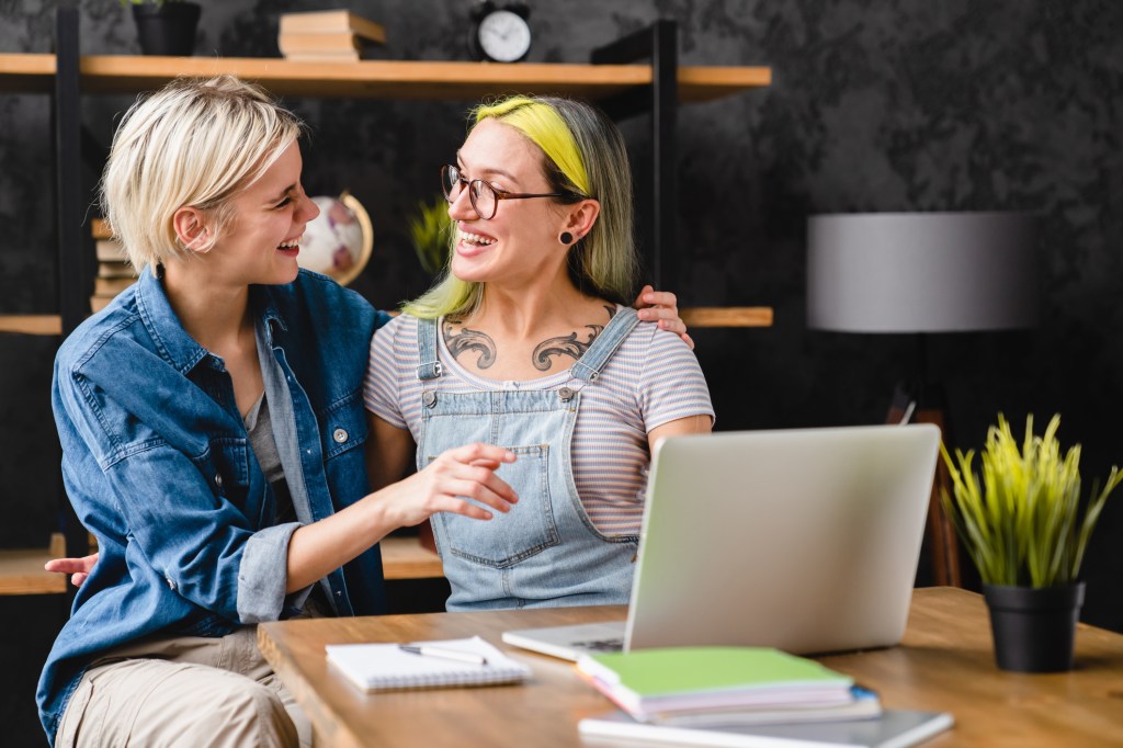 An LGBTQ couple reviewing estate plan options.