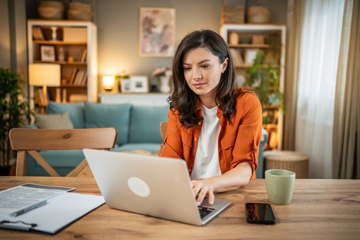 A woman setting up her first meeting with an advisor after completing a background check.