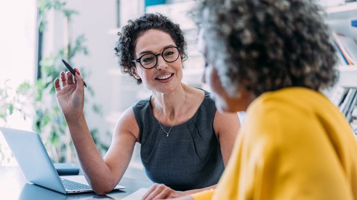 A financial advisor meets with a prospective client during an initial consultation with her.