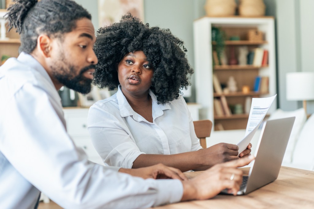 Real estate investors reviewing the key differences between landlord and homeowners insurance.