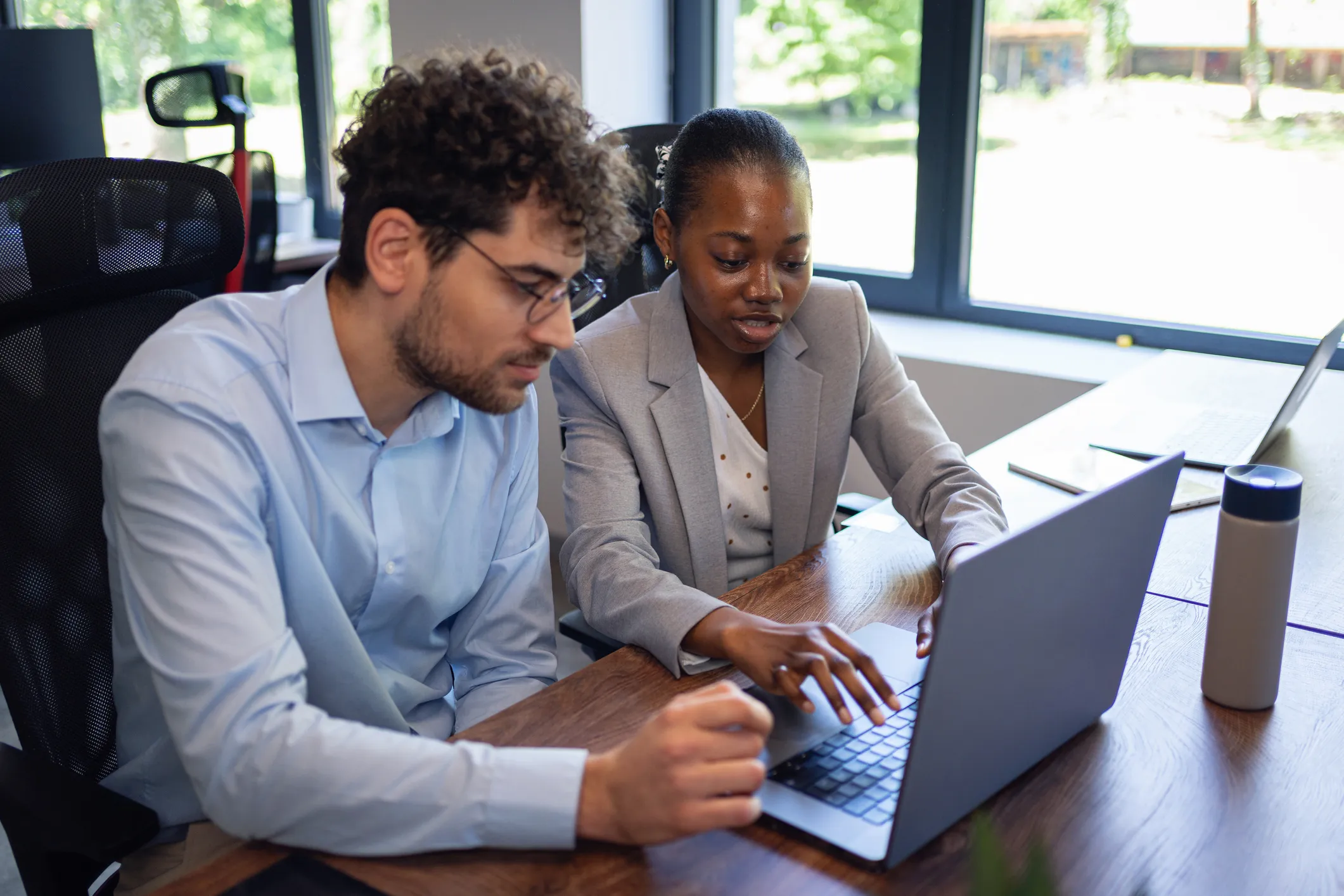 A financial advisor reviewing a real estate portfolio with a client.