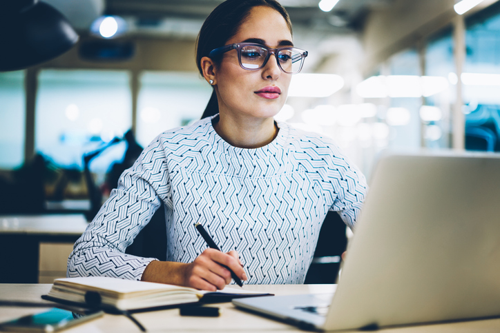 A woman looking up steps to create an emergency fund. 