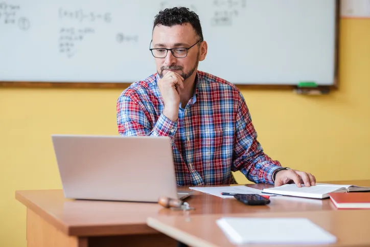 A public school teacher reviewing his retirement plan.