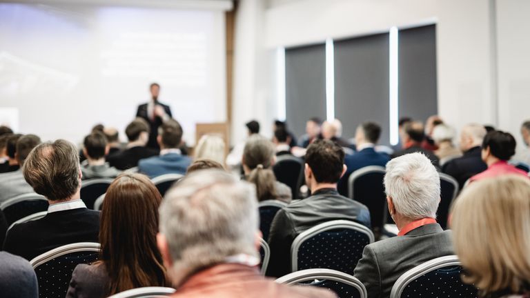 People listening to a speaker's presentation.