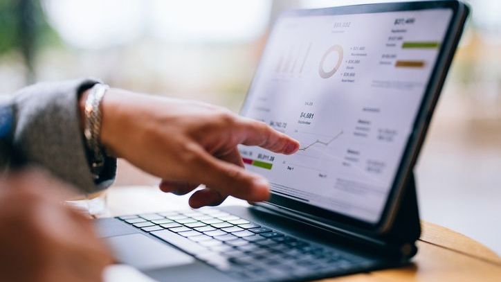 An investor reviews his portfolio's ETF holdings on his tablet. 