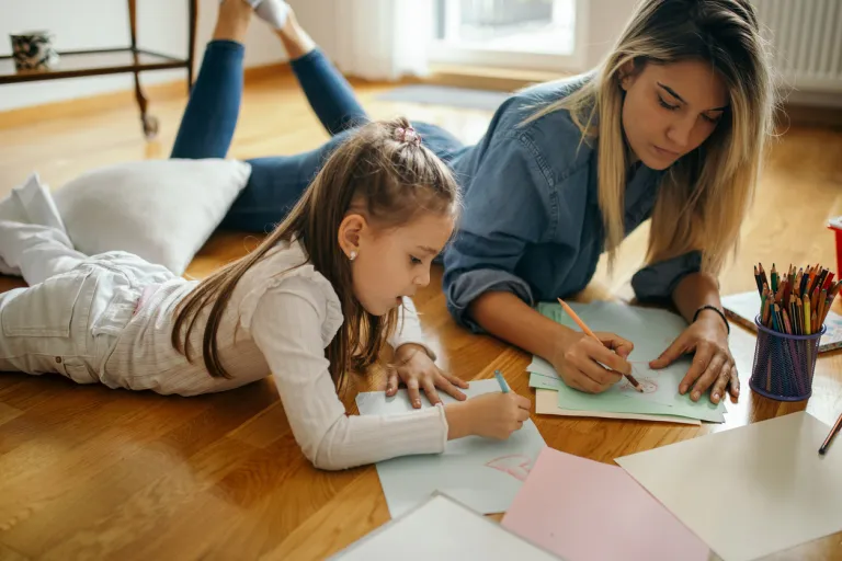 A nanny participating in educational activities with a girl.