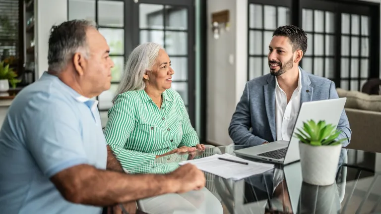 A couple meets with a financial advisor for a free consultation. 