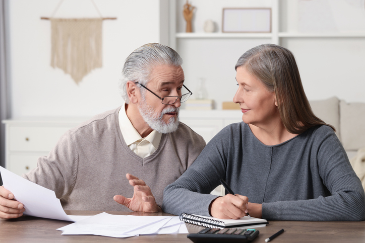 A senior couple reviewing estate plan documents.