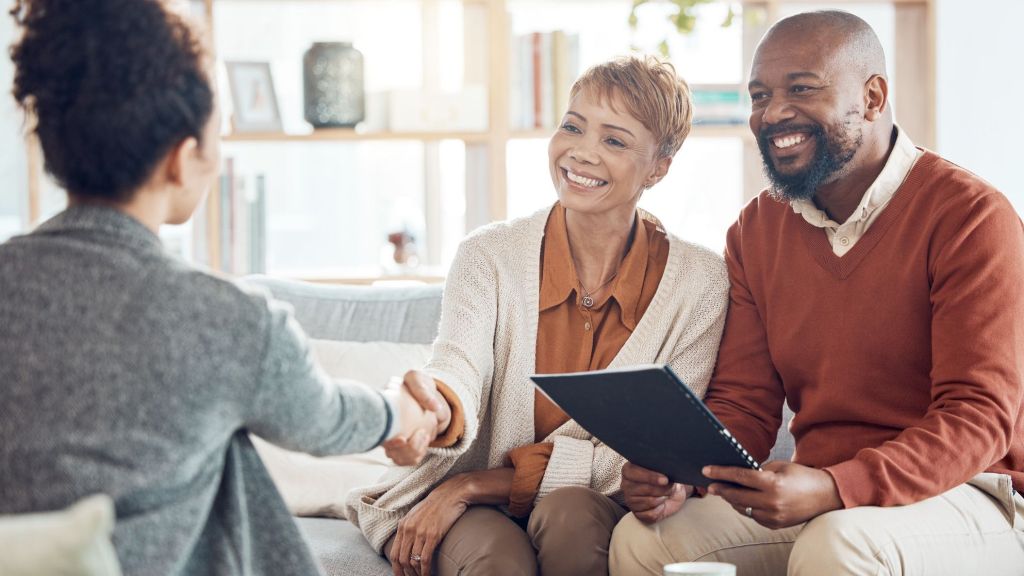 A married couple meets with a financial advisor whom they're considering hiring to manage their investment portfolio. 