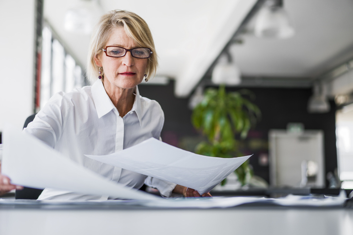 A woman considering the benefits and drawbacks of a deferred compensation plan.
