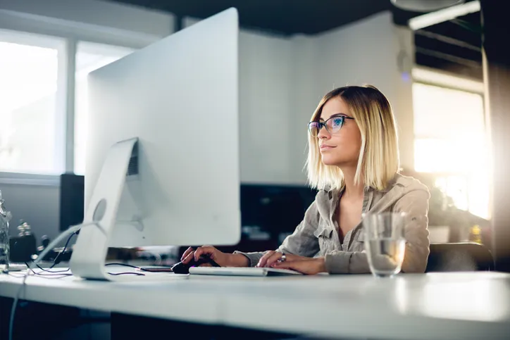 A woman looking up the pros and cons of investing in zero coupon bonds.