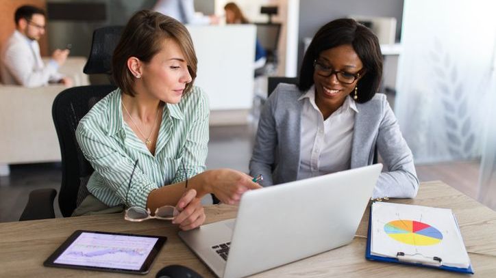 Two members of a company's finance department review its authorized stock plan.